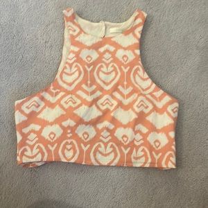 Peach and white crop top with open back and buttons.